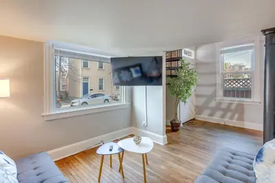 a living room with a couch and a tv at Cozy Boho-Chic Loft about 2 Mi to Downtown Cincinnati in Cincinnati