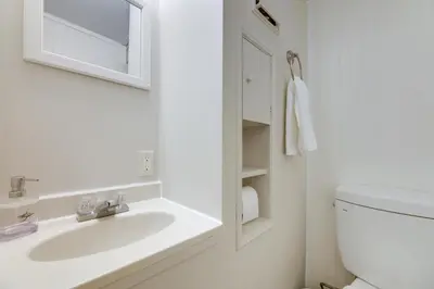 a white bathroom with a sink and a toilet at Cozy Boho-Chic Loft about 2 Mi to Downtown Cincinnati in Cincinnati