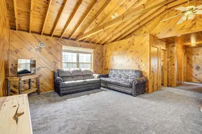 a living room with a couch and a tv at Racine Vacation Rental 25 Mi to Athens! in Racine