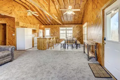 a kitchen and dining room in a log home at Racine Vacation Rental 25 Mi to Athens! in Racine