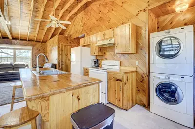 a kitchen with a washer and dryer in a cabin at Racine Vacation Rental 25 Mi to Athens! in Racine