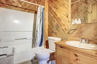 a bathroom with a white toilet and a sink at Racine Vacation Rental 25 Mi to Athens! in Racine