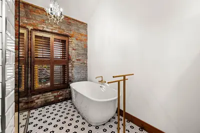 a bathroom with a white bath tub in a room at The Chandler Hotel in Madison