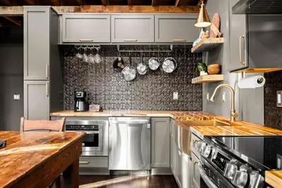 a kitchen with stainless steel appliances and wooden counters at The Chandler Hotel in Madison