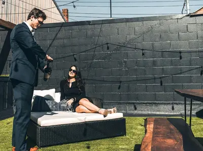 a man is standing next to a woman sitting on a bed at The Chandler Hotel in Madison