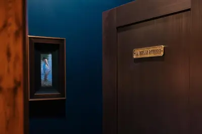 a door with a sign on it next to a mirror at The Chandler Hotel in Madison