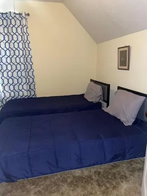 a bedroom with two beds with blue sheets at Cedar Point/Kalahari/Lake Erie - Betty's Homestead in Norwalk