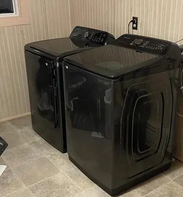 a microwave sitting on top of a black refrigerator at Cedar Point/Kalahari/Lake Erie - Betty's Homestead in Norwalk