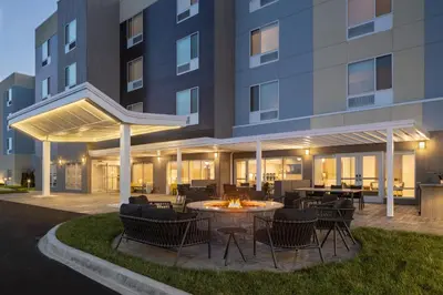 an outdoor patio with a fire pit in front of a building at TownePlace Suites by Marriott Georgetown in Georgetown