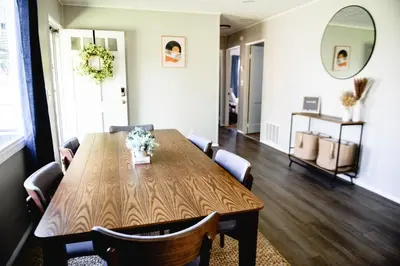 a dining room with a wooden table and chairs at Urban Cottage: Homey & Convenient in Huntington
