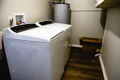 a small white refrigerator in a room at Urban Cottage: Homey & Convenient in Huntington