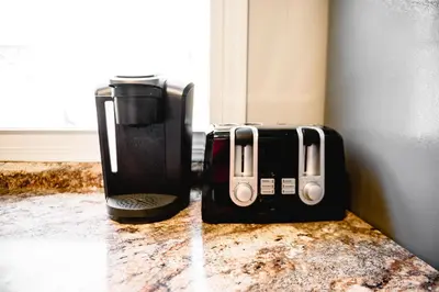 two coffeemakers sitting on a counter next to a window at Urban Cottage: Homey & Convenient in Huntington