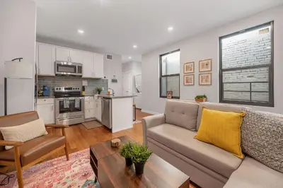 a living room with a couch and a table at Prime OTR steps to Vine St, Lux Full Bed, Workspace, fast WiFi, 50in Smart TV, Sleeps 3ppl in Cincinnati