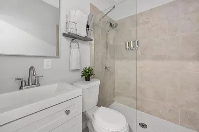 a bathroom with a shower and a toilet and a sink at Prime OTR steps to Vine St, Lux Full Bed, Workspace, fast WiFi, 50in Smart TV, Sleeps 3ppl in Cincinnati