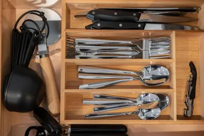 a wooden drawer filled with utensils in a kitchen at Prime OTR steps to Vine St, Lux Full Bed, Workspace, fast WiFi, 50in Smart TV, Sleeps 3ppl in Cincinnati