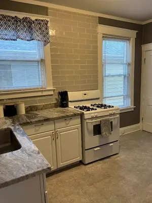 a kitchen with a white stove top oven next to a window at Rolston 1, One Bedroom Unit near Xavier Downtown in Bellevue