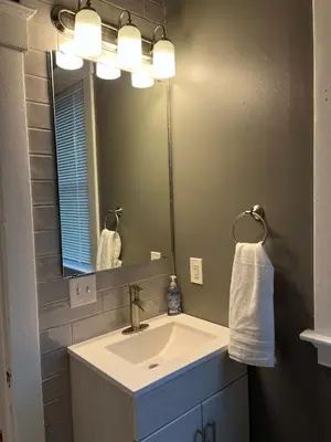 a bathroom with a sink and a mirror at Rolston 1, One Bedroom Unit near Xavier Downtown in Bellevue