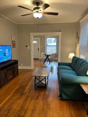 a living room with a green couch and a table at Rolston 1, One Bedroom Unit near Xavier Downtown in Bellevue