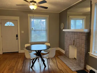 a dining room with a table and chairs and a fireplace at Rolston 1, One Bedroom Unit near Xavier Downtown in Bellevue