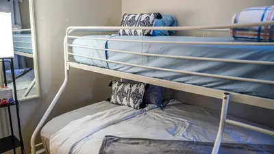 a bunk bed with two pillows on top of it at Cozy 3BR Condo near OSU Perfect for Students, Workers & Staycations in Columbus
