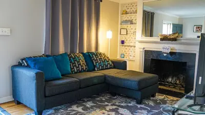 a living room with a couch and a fireplace at Cozy 3BR Condo near OSU Perfect for Students, Workers & Staycations in Columbus