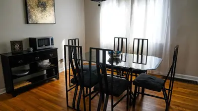 a dining room with a table and chairs and a microwave at Cozy 3BR Condo near OSU Perfect for Students, Workers & Staycations in Columbus