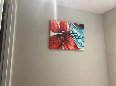 a painting hanging on a wall in a room at Cozy 3BR Condo near OSU Perfect for Students, Workers & Staycations in Columbus