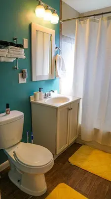 a bathroom with a white toilet and a sink at Cozy 3BR Condo near OSU Perfect for Students, Workers & Staycations in Columbus