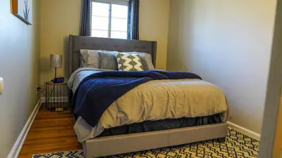 a bedroom with a large bed with a window at Cozy 3BR Condo near OSU Perfect for Students, Workers & Staycations in Columbus