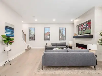 a living room with two couches and a fireplace at Chateau in the Village - Brand New 3BD 5BA in Columbus
