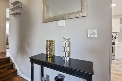 a black table in a living room with a mirror at The Blue Door Dream - Stunning design Very Quiet in Columbus