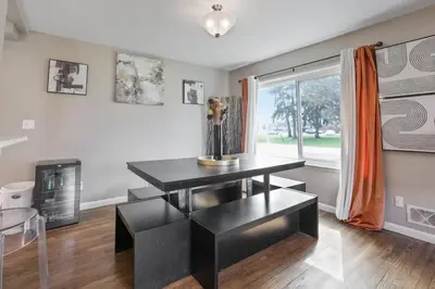 a dining room with a black table and a window at The Blue Door Dream - Stunning design Very Quiet in Columbus