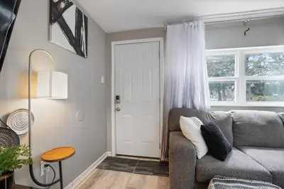 a living room with a gray couch and a door at The Blue Door Dream - Stunning design Very Quiet in Columbus