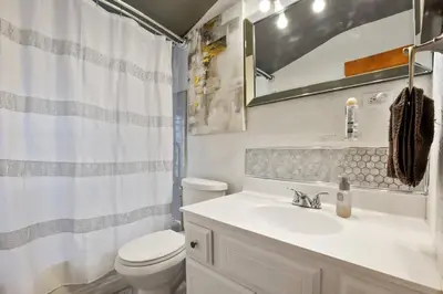 a bathroom with a sink and a toilet and a shower at The Blue Door Dream - Stunning design Very Quiet in Columbus