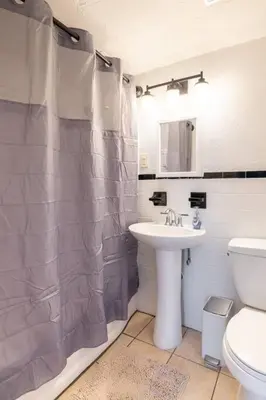 a bathroom with a sink and a shower curtain at King & Queen Memory foam beds! 2-4c Georgetown Villas in Fairview Park