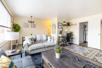 a living room with a couch and a table at King & Queen Memory foam beds! 2-4c Georgetown Villas in Fairview Park