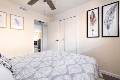 a bedroom with a bed and some pictures on the wall at King & Queen Memory Foam Beds 2-2b Georgetown Villas in Fairview Park