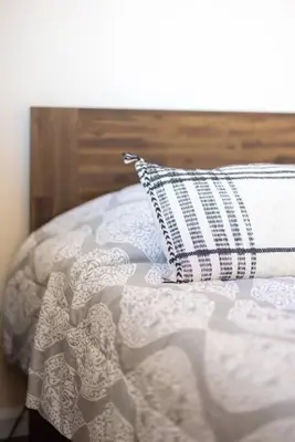 a white bed with a pillow on top of it at King & Queen Memory Foam Beds 2-2b Georgetown Villas in Fairview Park