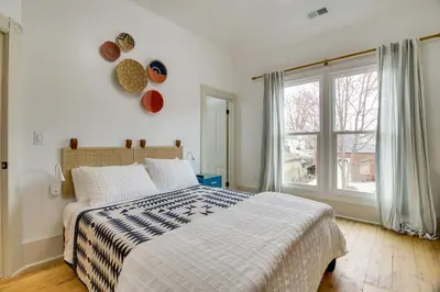 a bedroom with a bed and a large window at Indiana Vacation Rental Walk to Madison Main St! in Madison