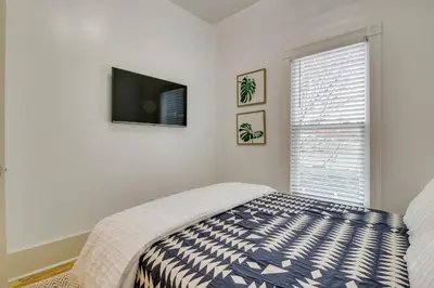 a bedroom with a bed and a flat screen tv at Indiana Vacation Rental Walk to Madison Main St! in Madison