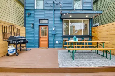 a blue house with a picnic table and a grill at Indiana Vacation Rental Walk to Madison Main St! in Madison