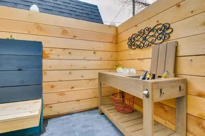 a bathroom with a wooden wall with a wooden sink at Indiana Vacation Rental Walk to Madison Main St! in Madison