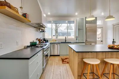a kitchen with white walls and a black counter top at Indiana Vacation Rental Walk to Madison Main St! in Madison