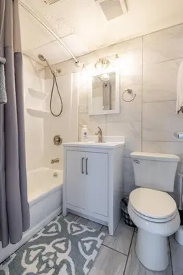 a bathroom with a toilet and a sink and a tub at Near CLE airport and Valley 2-4a Georgetown Villas in Fairview Park