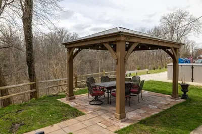 a wooden gazebo with a table and chairs at Near CLE airport and Valley 2-4a Georgetown Villas in Fairview Park