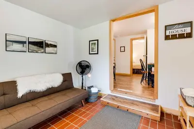 a living room with a couch and a dining room at Lakeside Indiana Vacation Rental Near Fort Wayne! in Churubusco