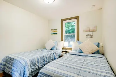 two beds sitting next to each other in a bedroom at Lakeside Indiana Vacation Rental Near Fort Wayne! in Churubusco