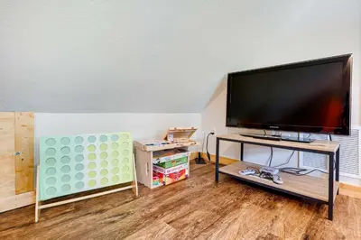 a living room with a large flat screen tv at Lakeside Indiana Vacation Rental Near Fort Wayne! in Churubusco