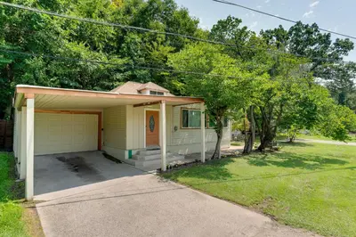 a small house with a garage in a yard at Lakeside Indiana Vacation Rental Near Fort Wayne! in Churubusco