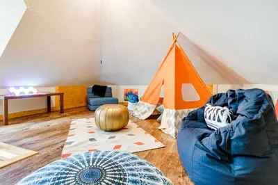 a living room with a couch and a tent at Lakeside Indiana Vacation Rental Near Fort Wayne! in Churubusco
